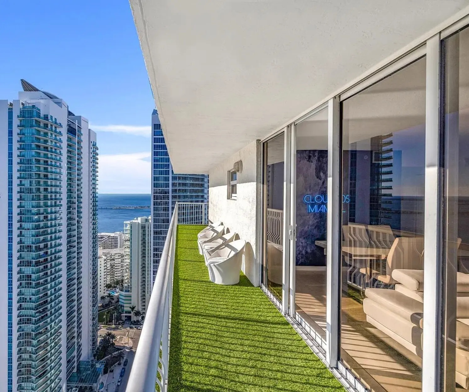 Bay-view balcony beside glass doors opening into the living room