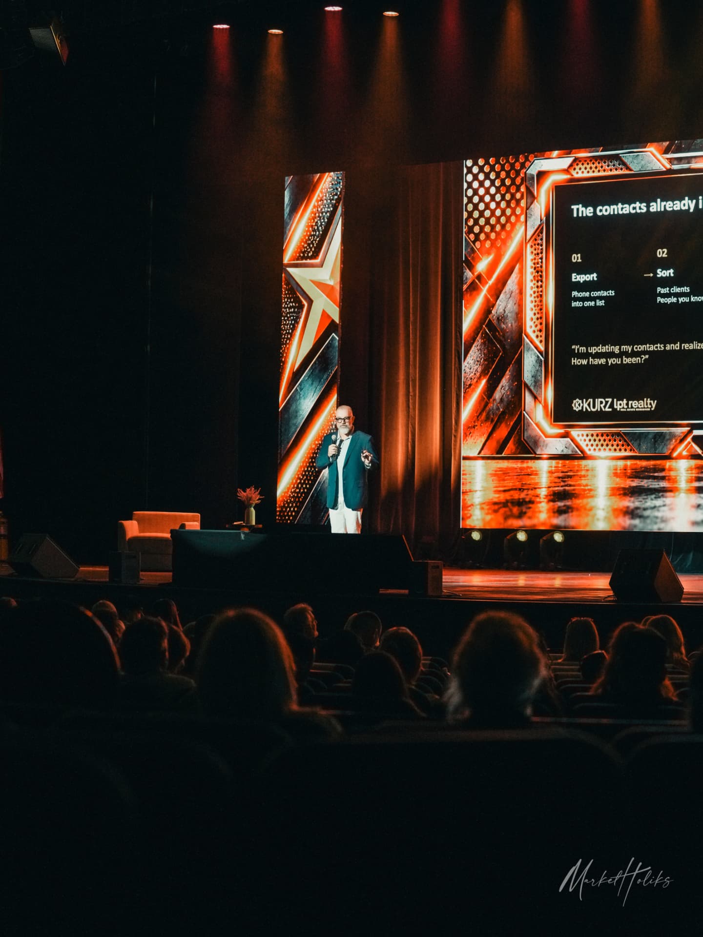 David Adam Kurz speaking on stage with a microphone